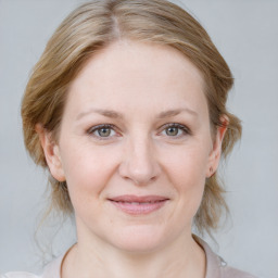 Joyful white young-adult female with medium  brown hair and blue eyes