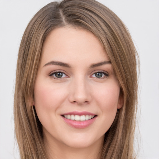 Joyful white young-adult female with long  brown hair and green eyes