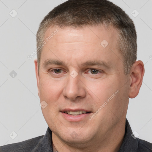 Joyful white adult male with short  brown hair and brown eyes