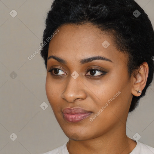 Joyful black young-adult female with short  black hair and brown eyes