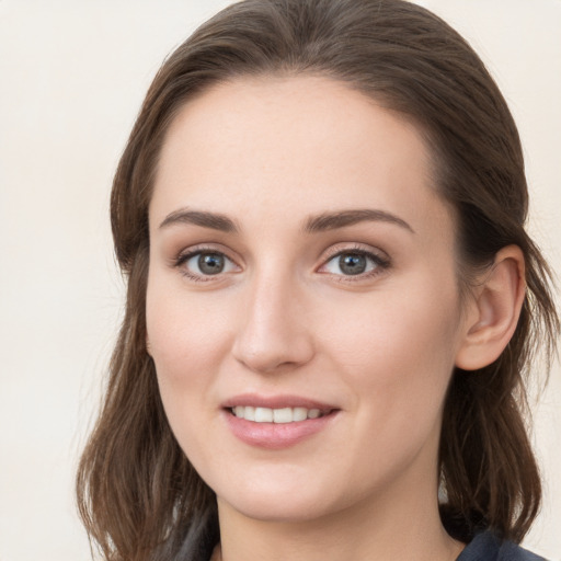 Joyful white young-adult female with medium  brown hair and grey eyes