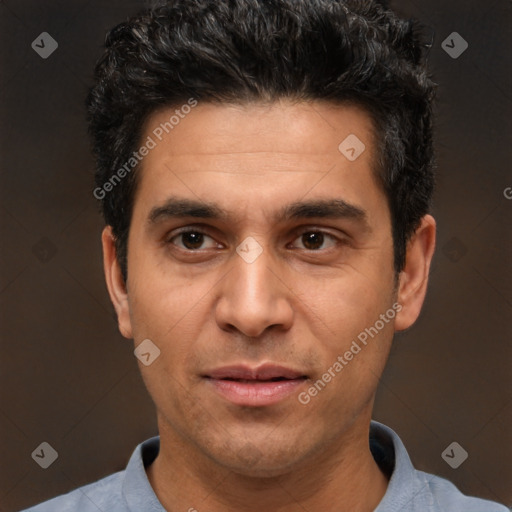 Joyful white adult male with short  black hair and brown eyes