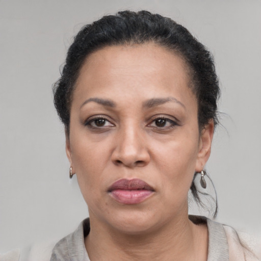 Neutral latino adult female with short  black hair and brown eyes