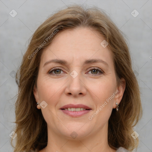 Joyful white adult female with medium  brown hair and grey eyes