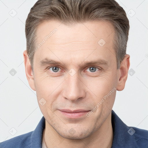 Joyful white adult male with short  brown hair and grey eyes