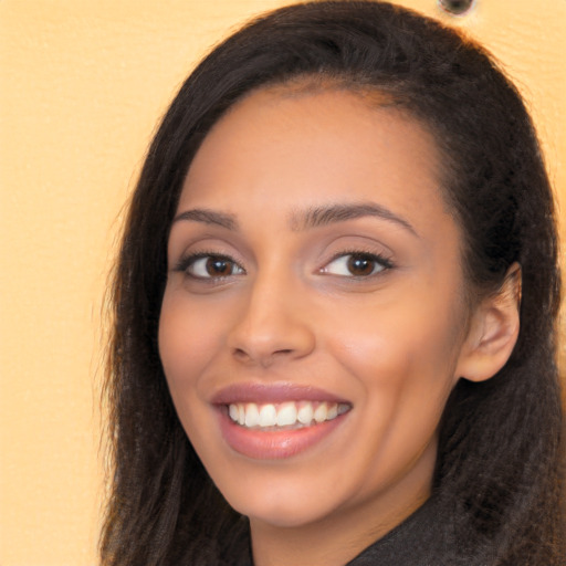 Joyful latino young-adult female with long  brown hair and brown eyes