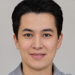 Joyful asian young-adult male with short  black hair and brown eyes