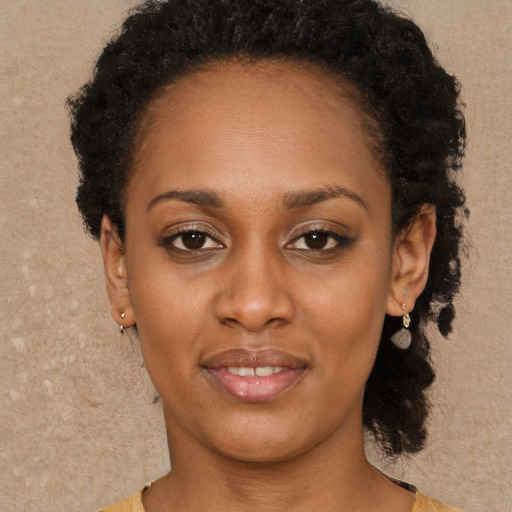 Joyful black young-adult female with short  brown hair and brown eyes