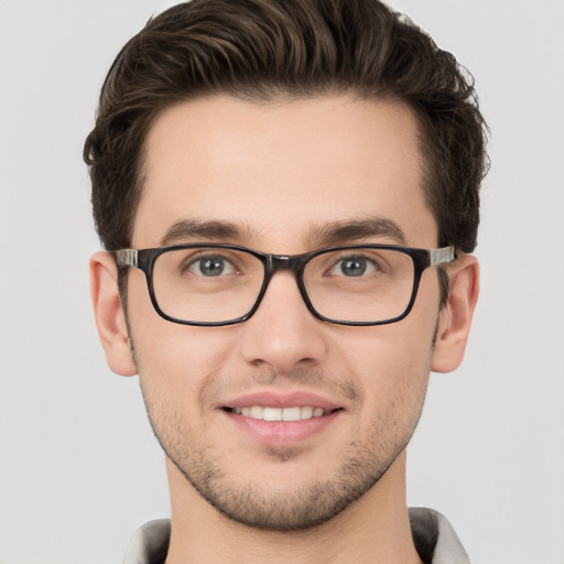 Joyful white young-adult male with short  brown hair and grey eyes