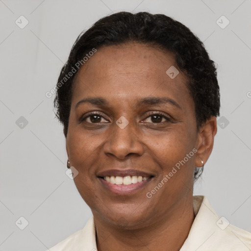 Joyful black adult female with short  brown hair and brown eyes