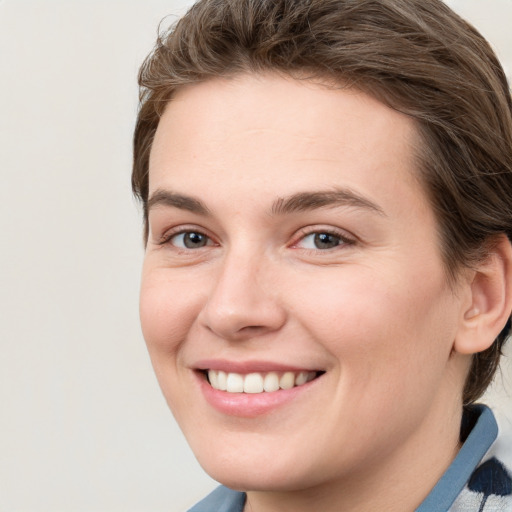 Joyful white young-adult female with medium  brown hair and blue eyes