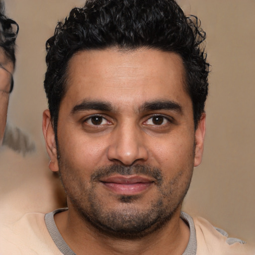 Joyful latino young-adult male with short  black hair and brown eyes