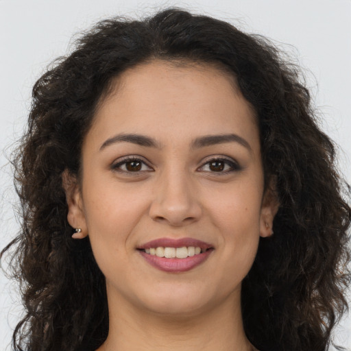 Joyful white young-adult female with long  brown hair and brown eyes