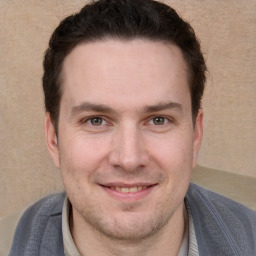 Joyful white adult male with short  brown hair and grey eyes