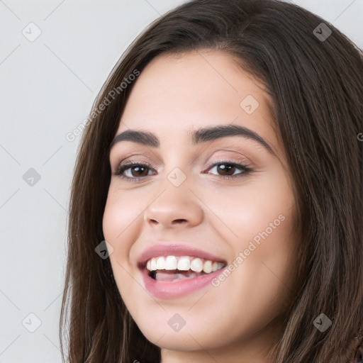 Joyful white young-adult female with long  brown hair and brown eyes