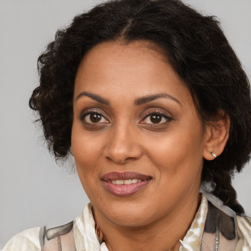 Joyful black adult female with medium  brown hair and brown eyes