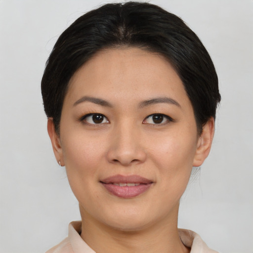 Joyful asian young-adult female with short  brown hair and brown eyes