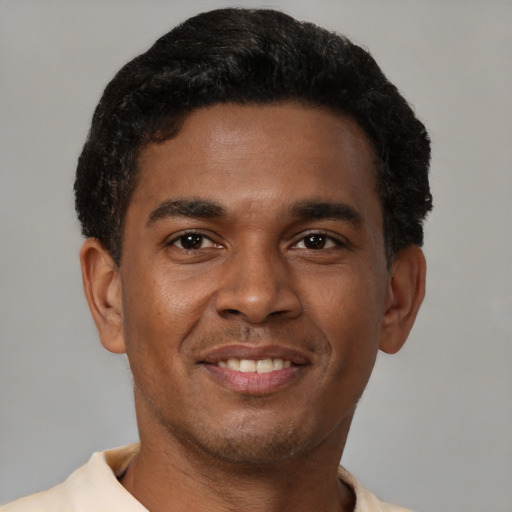 Joyful latino young-adult male with short  brown hair and brown eyes