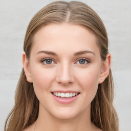 Joyful white young-adult female with long  brown hair and blue eyes