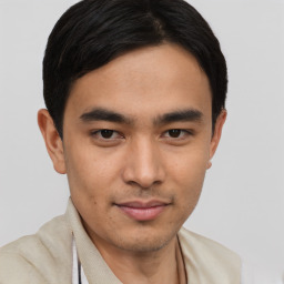 Joyful latino young-adult male with short  brown hair and brown eyes