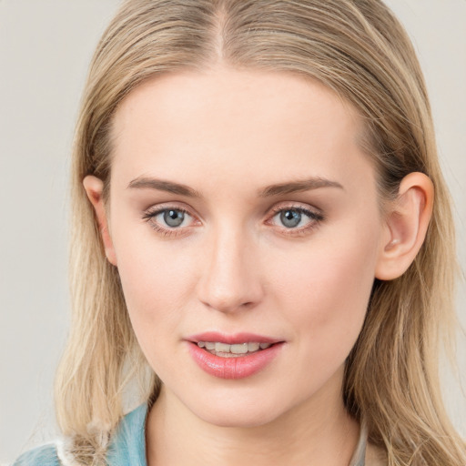 Joyful white young-adult female with long  brown hair and blue eyes