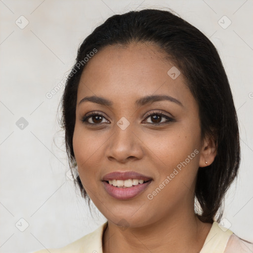 Joyful latino young-adult female with medium  brown hair and brown eyes