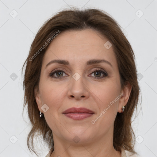 Joyful white adult female with medium  brown hair and grey eyes