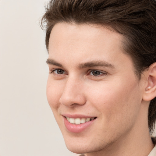 Joyful white young-adult male with medium  brown hair and brown eyes