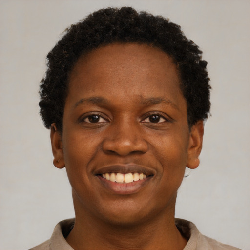 Joyful black young-adult female with short  black hair and brown eyes