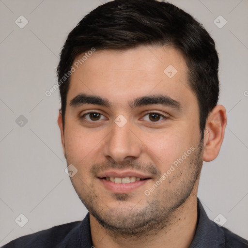 Joyful white young-adult male with short  black hair and brown eyes