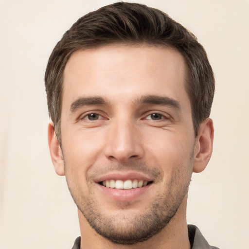 Joyful white young-adult male with short  brown hair and brown eyes