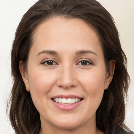 Joyful white young-adult female with long  brown hair and brown eyes