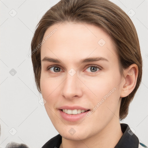 Joyful white young-adult female with medium  brown hair and grey eyes