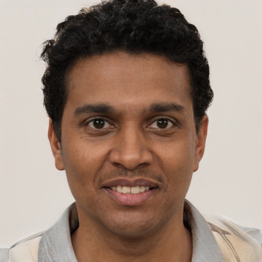 Joyful black young-adult male with short  black hair and brown eyes