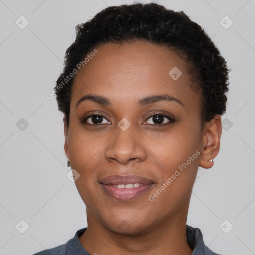 Joyful black young-adult female with short  black hair and brown eyes