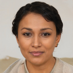 Joyful latino young-adult female with short  brown hair and brown eyes