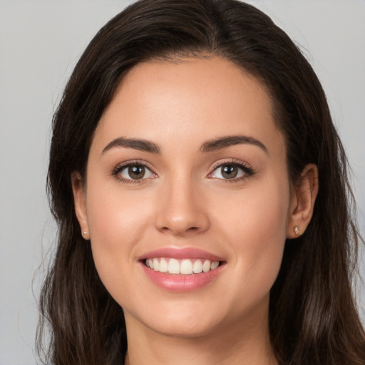 Joyful white young-adult female with long  brown hair and brown eyes