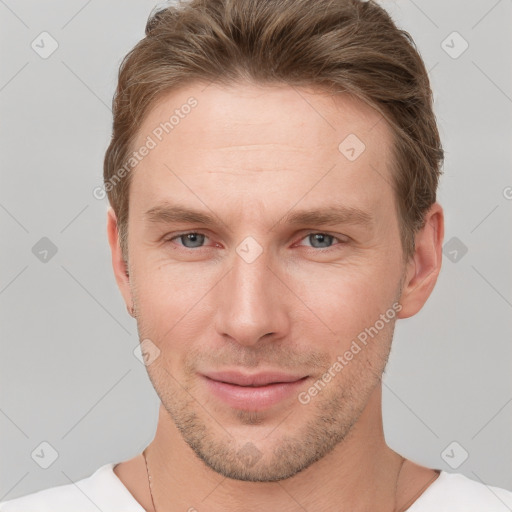 Joyful white young-adult male with short  brown hair and grey eyes