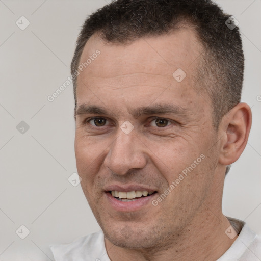 Joyful white adult male with short  brown hair and brown eyes