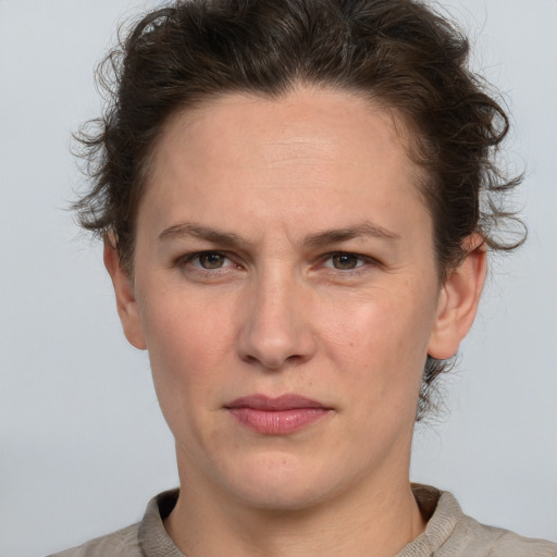 Joyful white adult female with short  brown hair and grey eyes