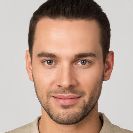 Joyful white young-adult male with short  brown hair and brown eyes