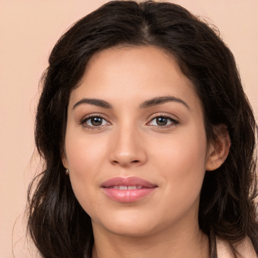 Joyful white young-adult female with long  brown hair and brown eyes