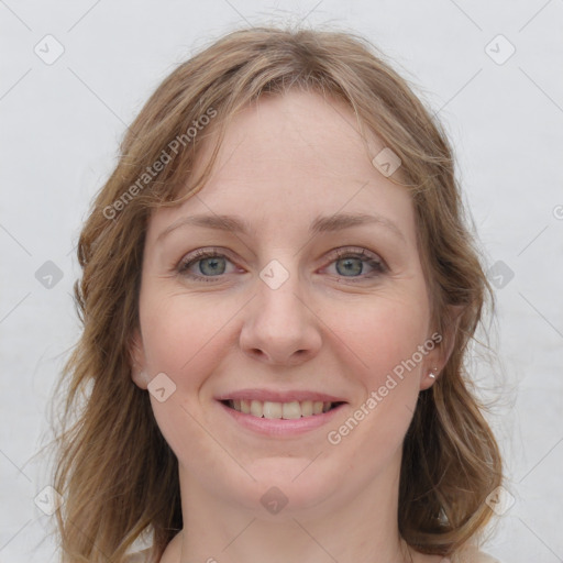 Joyful white young-adult female with medium  brown hair and blue eyes