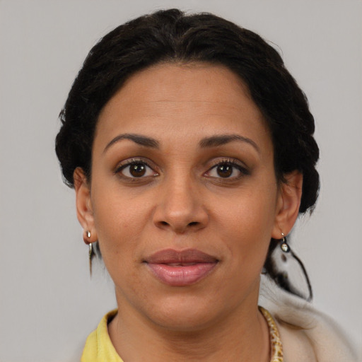 Joyful latino young-adult female with short  brown hair and brown eyes