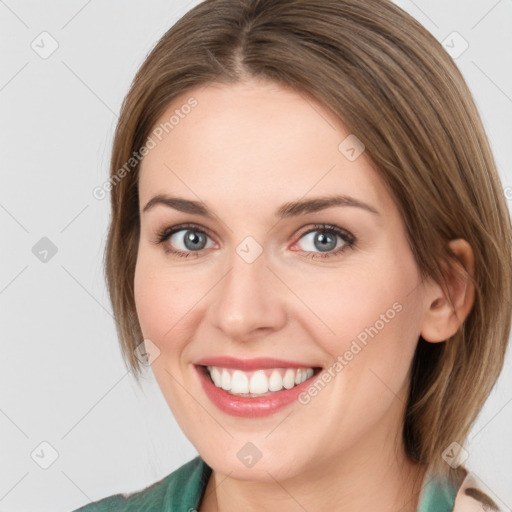 Joyful white young-adult female with medium  brown hair and green eyes