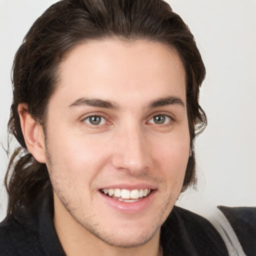 Joyful white young-adult male with medium  brown hair and brown eyes