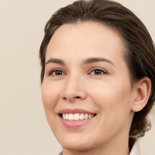 Joyful white young-adult female with medium  brown hair and brown eyes