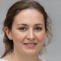 Joyful white adult female with medium  brown hair and grey eyes