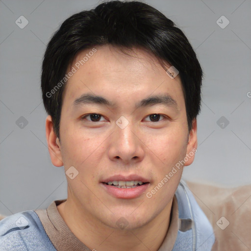 Joyful asian young-adult male with short  brown hair and brown eyes