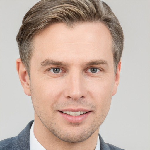 Joyful white adult male with short  brown hair and grey eyes